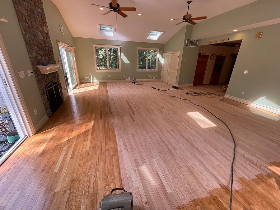 Living room hardwood floor half sanded, half with the old finish